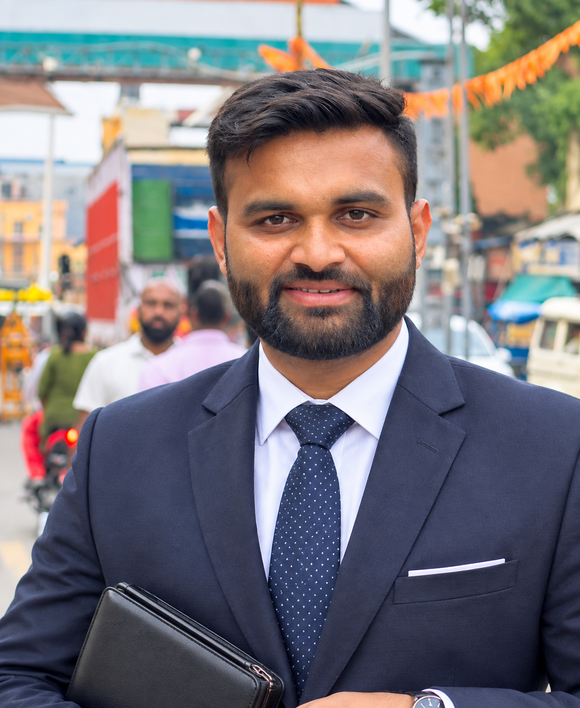 Mikin Patel, Chief Operating Officer of Sarvamangal, wearing a navy suit and tie