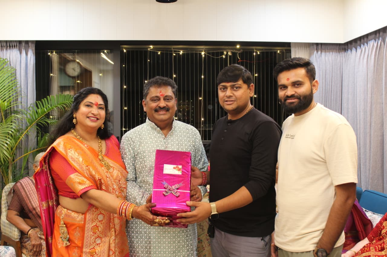 A couple receiving a pink-wrapped gift from the Sarvamangal team